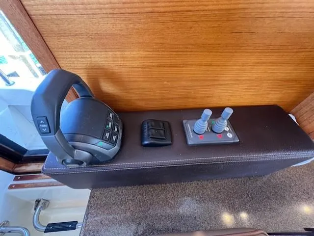 Slide: The Image of Control panel of 2020 Ranger Tugs R-31 CB with throttle and joystick controls. - 16