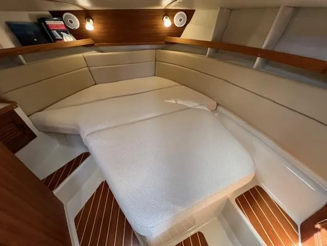 Slide: The Image of 2020 Ranger Tugs R-31 CB cabin interior with cozy bed and wooden accents. - 17