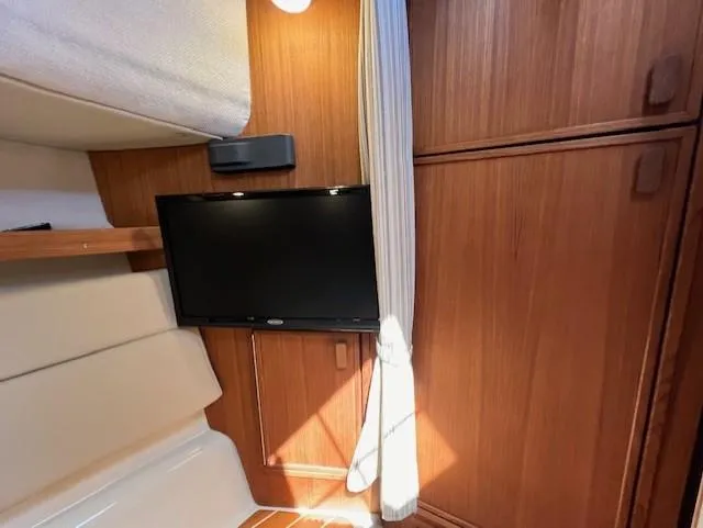 Slide: The Image of Interior of 2020 Ranger Tugs R-31 CB with TV and wooden cabinetry. - 18