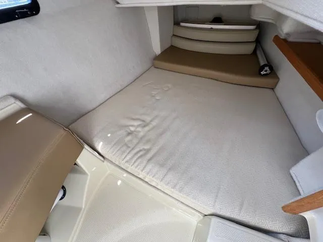 Slide: The Image of Interior cabin of 2020 Ranger Tugs R-31 CB with beige cushions and compact layout. - 21