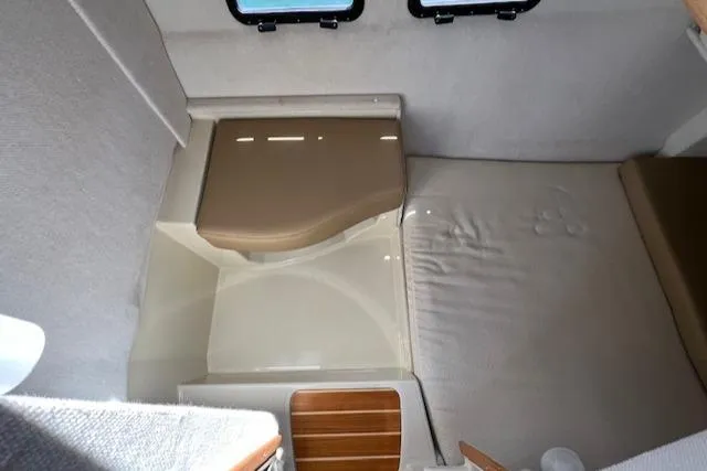 Slide: The Image of 2020 Ranger Tugs R-31 CB interior cabin with compact bed and seating area. - 22