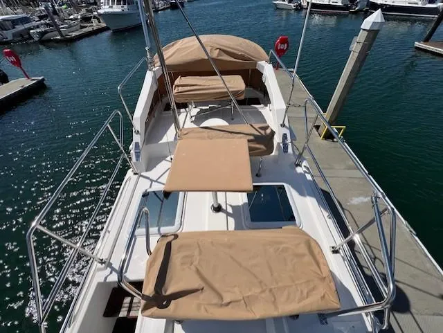 Slide: The Image of 2020 Ranger Tugs R-31 CB boat docked, featuring tan covers and spacious deck layout. - 24