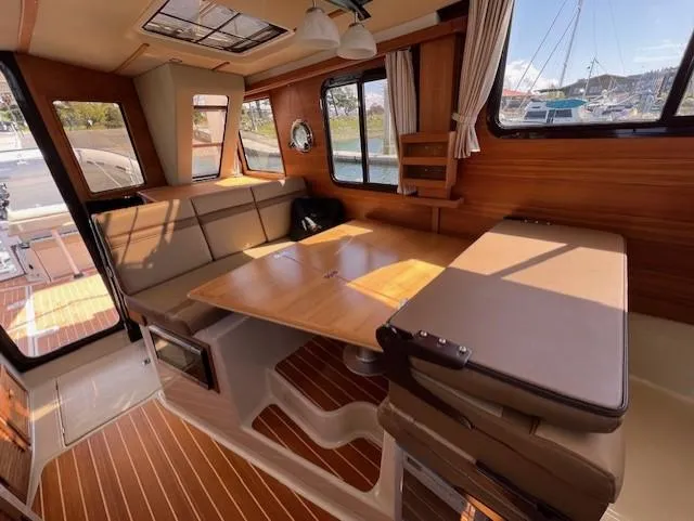 Slide: The Image of Interior of 2020 Ranger Tugs R-31 CB with wood accents and spacious seating area. - 8