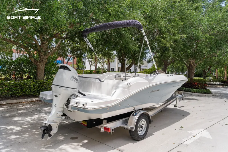 Slide: The Image of 2021 Hurricane SS 205 boat on trailer, parked outdoors under trees. - 3