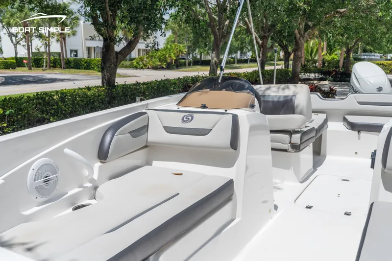 Slide: The Image of 2021 Hurricane SS 205 boat interior with seating, trees in background. - 8
