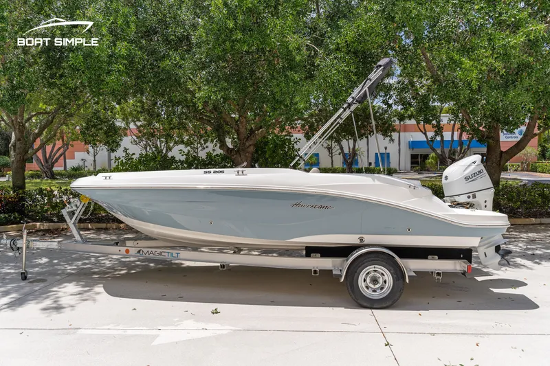 Slide: The Image of 2021 Hurricane SS 205 boat on trailer, parked outdoors with trees in background. - 0