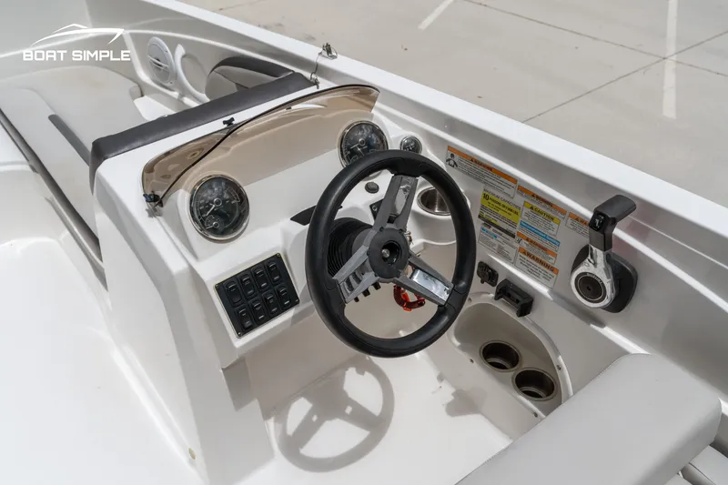 Slide: The Image of 2021 Hurricane SS 205 boat dashboard with steering wheel and controls. - 11