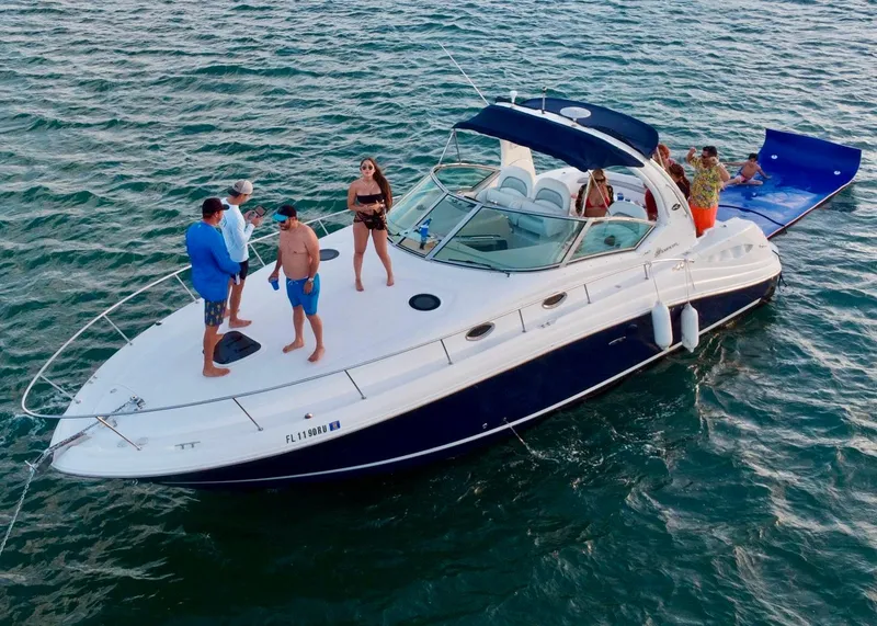 Slide: The Image of 2004 Sea Ray 340 Sundancer yacht with people enjoying a day on the water. - 2