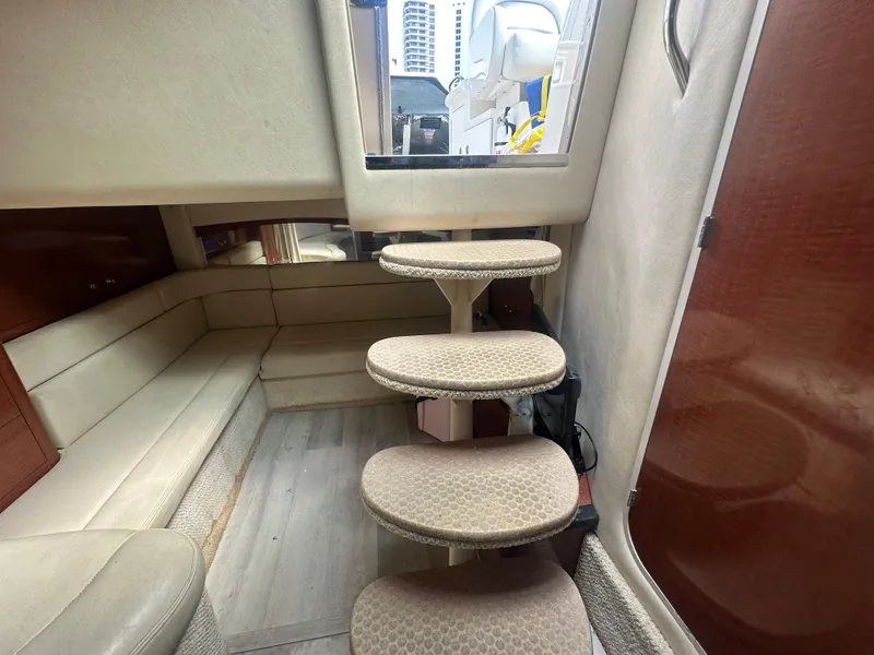 Slide: The Image of Interior of 2004 Sea Ray 340 Sundancer with beige seating and carpeted steps. - 28