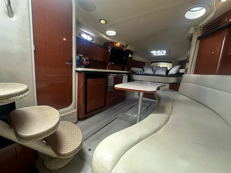 Slide: The Image of 2004 Sea Ray 340 Sundancer interior with kitchen, seating, and stairs. Luxurious yacht cabin design. - 29