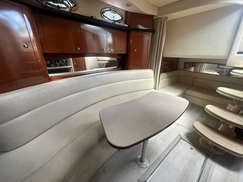 Slide: The Image of 2004 Sea Ray 340 Sundancer interior with elegant seating and wooden cabinetry. - 35