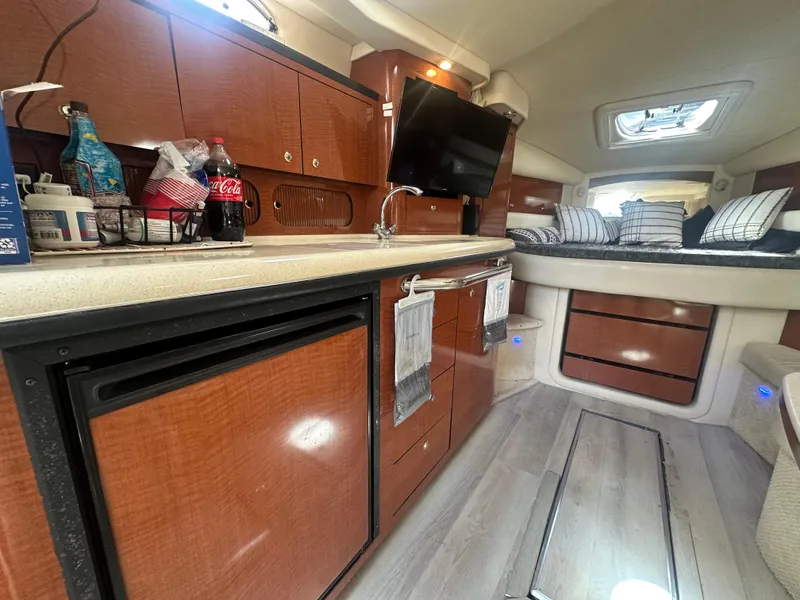 Slide: The Image of Interior of 2004 Sea Ray 340 Sundancer yacht with kitchenette and cozy sleeping area. - 40