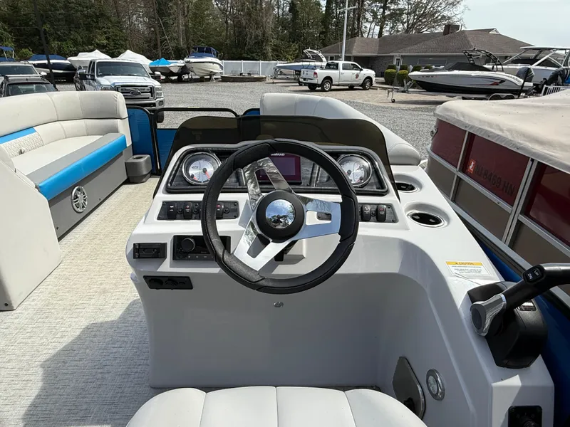 Slide: The Image of 2021 Godfrey SWEETWATER 2286 MT boat dashboard with steering wheel and controls. - 11