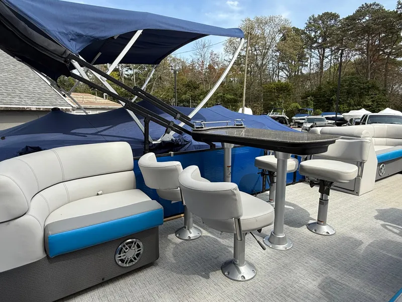 Slide: The Image of 2021 Godfrey SWEETWATER 2286 MT pontoon boat with seating and canopy, docked outdoors. - 14