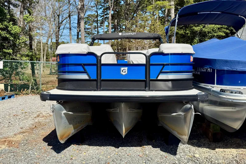 Slide: The Image of 2021 Godfrey SWEETWATER 2286 MT pontoon boat, blue exterior, parked outdoors. - 2