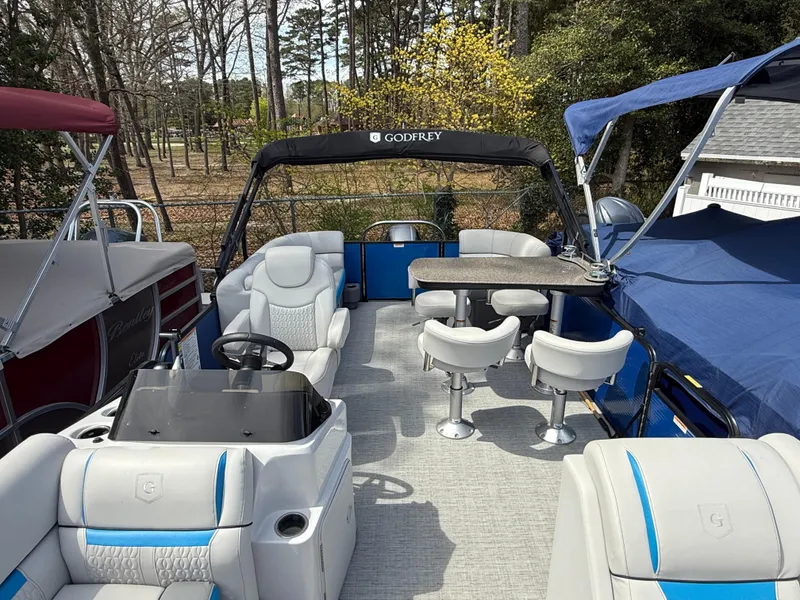 Slide: The Image of Pontoon boat interior, 2021 Godfrey SWEETWATER 2286 MT, featuring seating and table setup. - 9