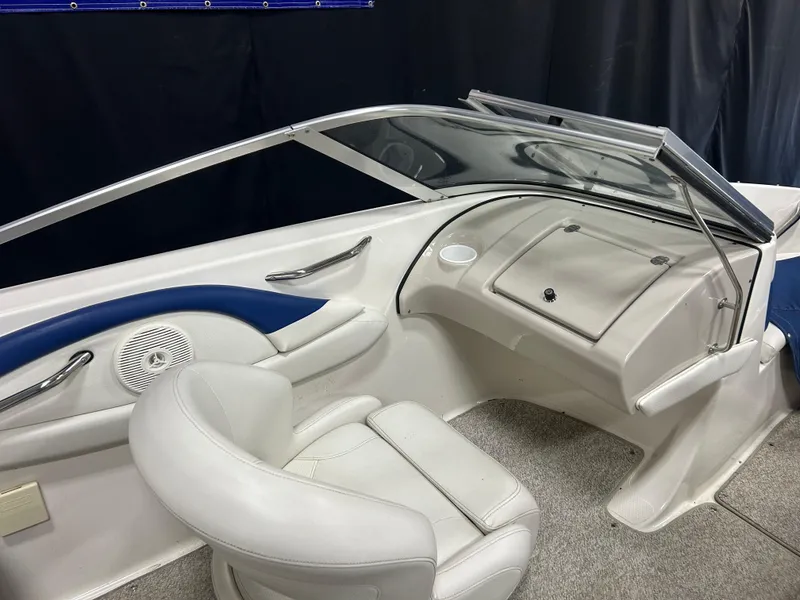 Slide: The Image of 2007 Larson 180 Sport boat interior with white seating and dashboard. - 10