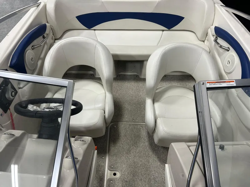 Slide: The Image of 2007 Larson 180 Sport boat interior with white seating and blue accents. - 11