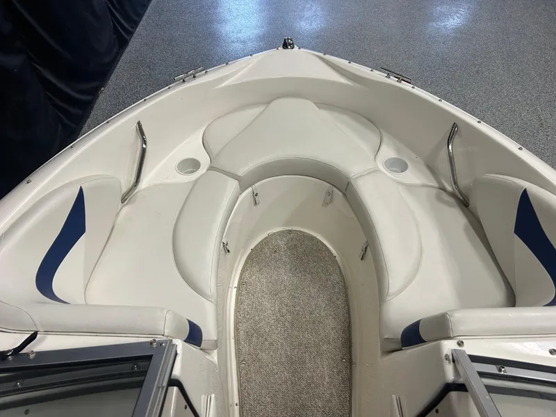 Slide: The Image of 2007 Larson 180 Sport boat interior with white seating and blue accents. - 6