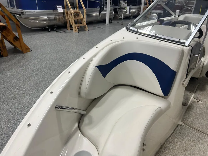 Slide: The Image of 2007 Larson 180 Sport boat interior with blue and white seating in showroom. - 7