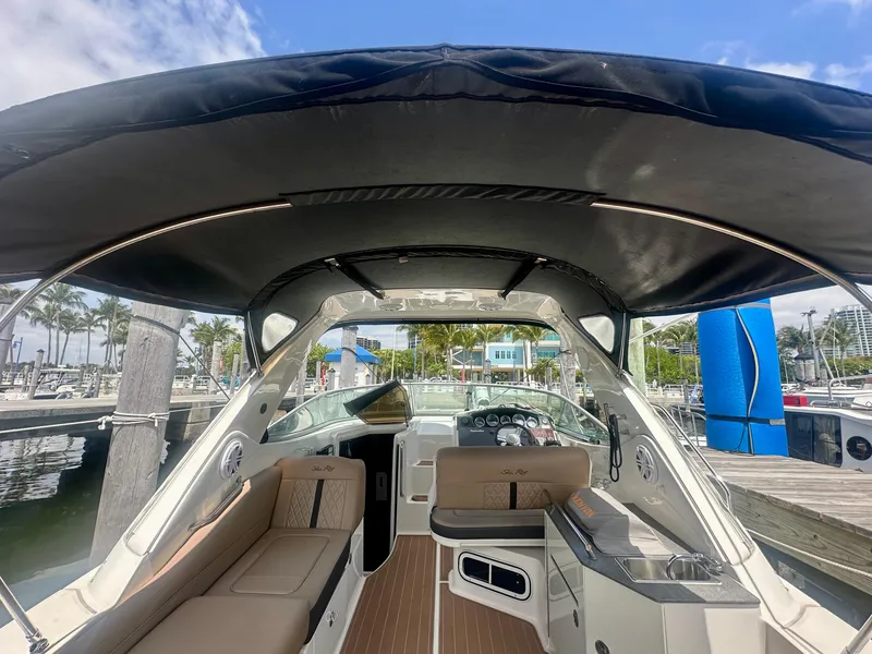 Slide: The Image of 2012 Sea Ray 310 Sundancer boat interior with canopy, docked at marina. - 12
