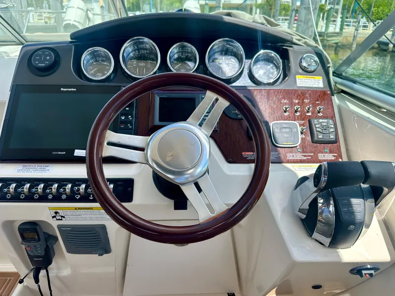 Slide: The Image of Helm of 2012 Sea Ray 310 Sundancer with gauges, steering wheel, and controls. - 20