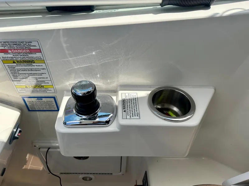 Slide: The Image of Control panel and cup holder on 2012 Sea Ray 310 Sundancer boat. - 22