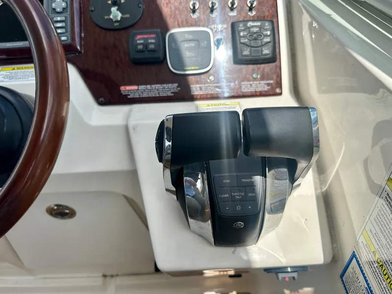 Slide: The Image of 2012 Sea Ray 310 Sundancer helm controls and dashboard close-up. - 23