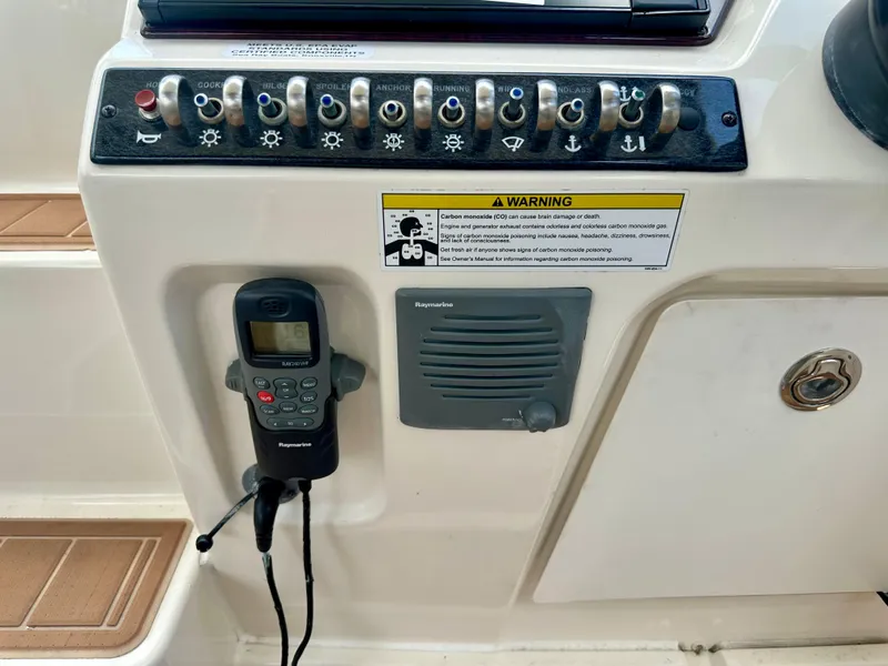 Slide: The Image of Control panel of a 2012 Sea Ray 310 Sundancer boat with radio and warning label. - 24