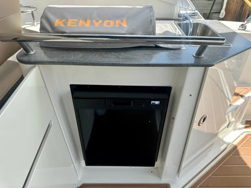 Slide: The Image of 2012 Sea Ray 310 Sundancer kitchenette with Kenyon grill and compact fridge. - 31