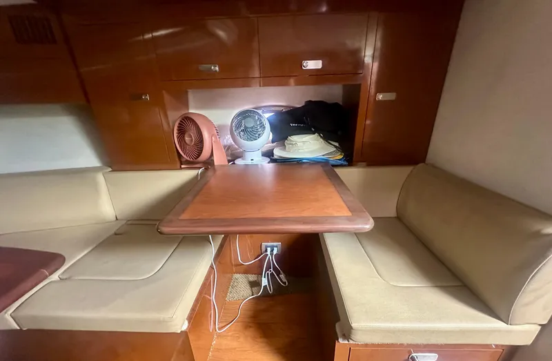 Slide: The Image of Interior of 2012 Sea Ray 310 Sundancer with seating and table setup. - 35