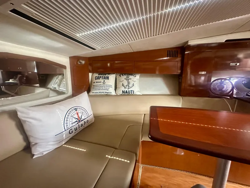 Slide: The Image of Interior of 2012 Sea Ray 310 Sundancer with cozy seating and nautical decor. - 38