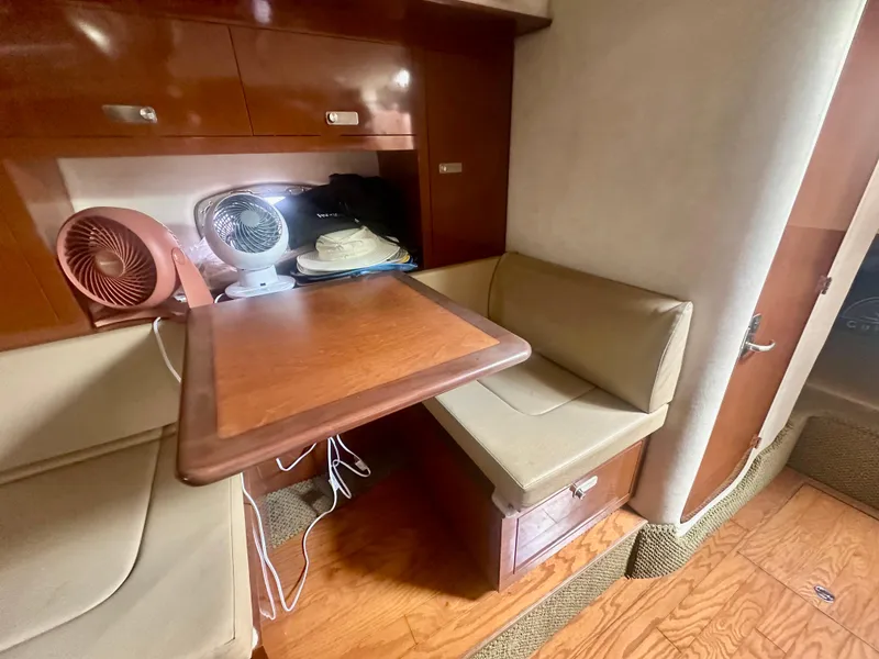 Slide: The Image of 2012 Sea Ray 310 Sundancer cabin interior with seating and table. - 40