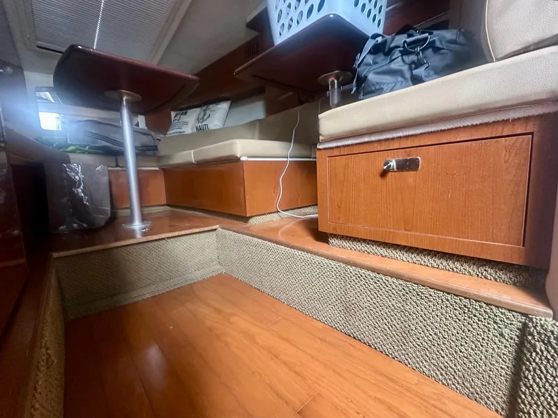 Slide: The Image of Interior of 2012 Sea Ray 310 Sundancer with wood flooring and seating area. - 43