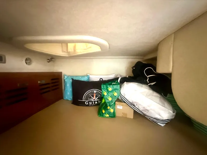 Slide: The Image of Cozy cabin interior of 2012 Sea Ray 310 Sundancer with cushions and bags. - 47