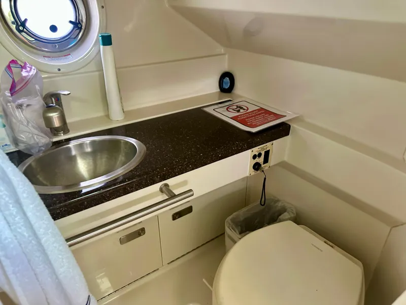 Slide: The Image of Bathroom interior of 2012 Sea Ray 310 Sundancer yacht, featuring sink and toilet. - 49