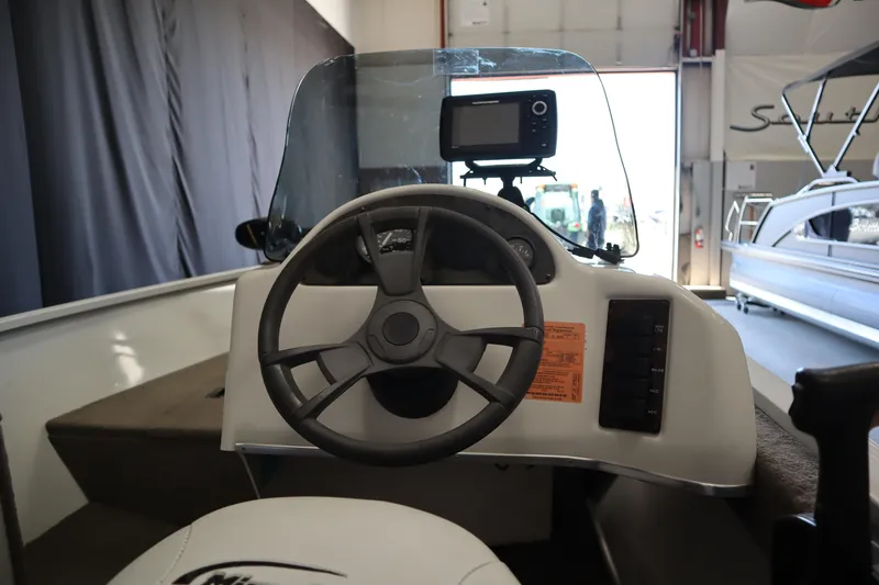 Slide: The Image of 2013 MirroCraft 1416 Troller boat dashboard with steering wheel and navigation system. - 13