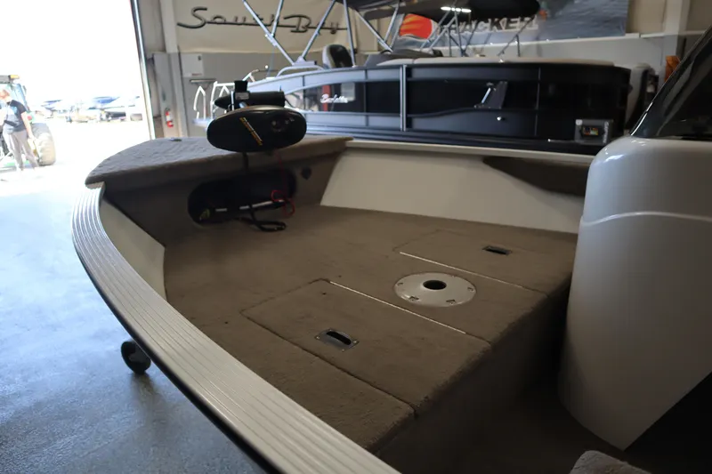 Slide: The Image of 2013 MirroCraft 1416 Troller boat interior with carpeted deck and storage compartments. - 15