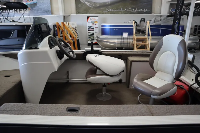 Slide: The Image of 2013 MirroCraft 1416 Troller boat interior with steering console and seating. - 17