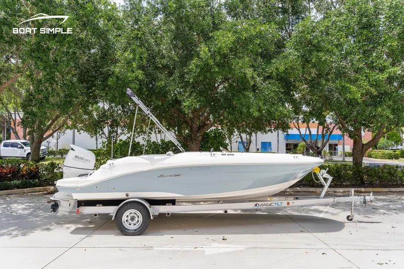Slide: The Image of 2021 Hurricane SS 205 boat on trailer, parked outdoors with trees in the background. - 4