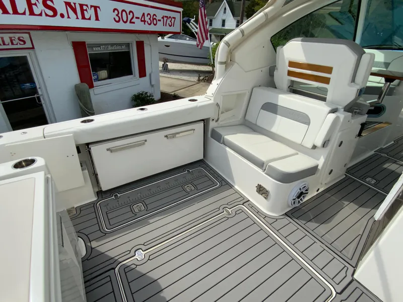 Slide: The Image of 2023 Pursuit DC 326 Dual Console boat interior with seating and storage, showcasing modern design. - 12