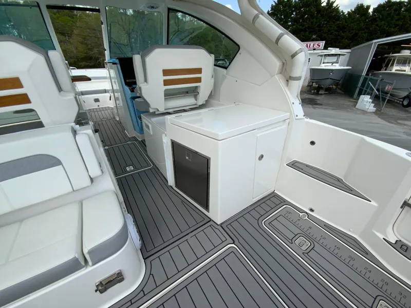 Slide: The Image of 2023 Pursuit DC 326 Dual Console boat interior with seating and storage. - 14