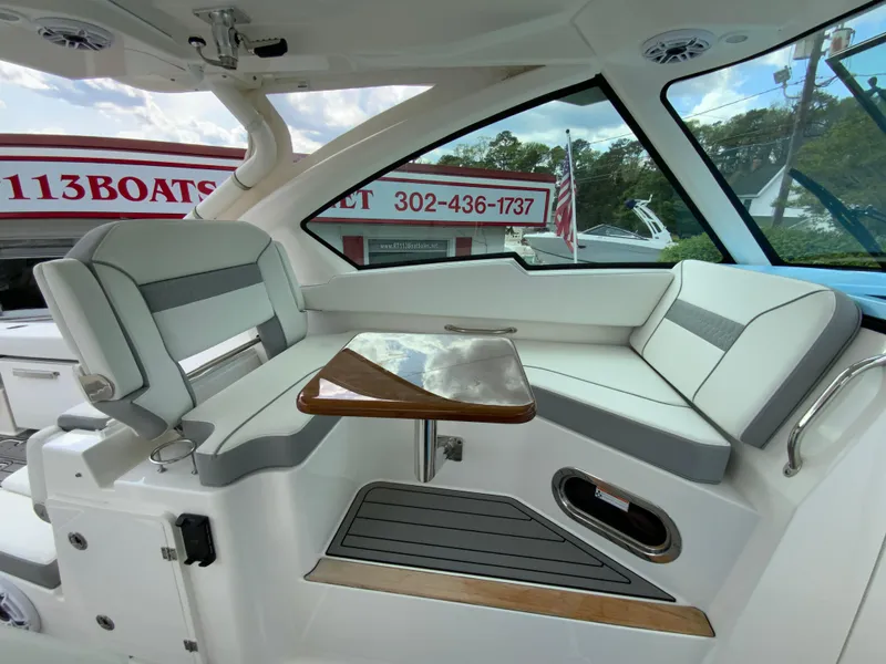 Slide: The Image of 2023 Pursuit DC 326 Dual Console interior with seating and table, showcasing modern design. - 20