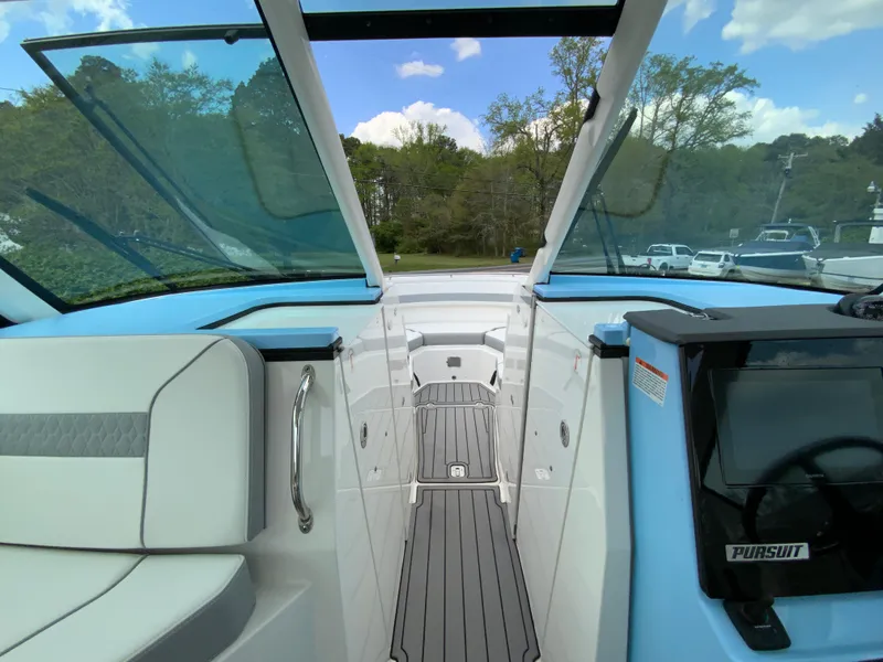 Slide: The Image of 2023 Pursuit DC 326 Dual Console boat interior with open deck and seating. - 21