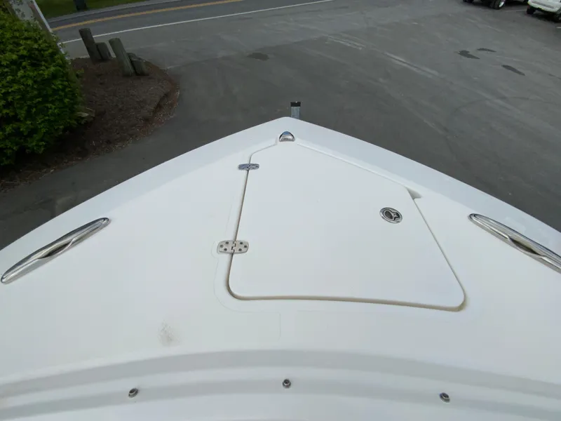 Slide: The Image of 2023 Pursuit DC 326 Dual Console boat bow with storage hatch and cleats. - 24