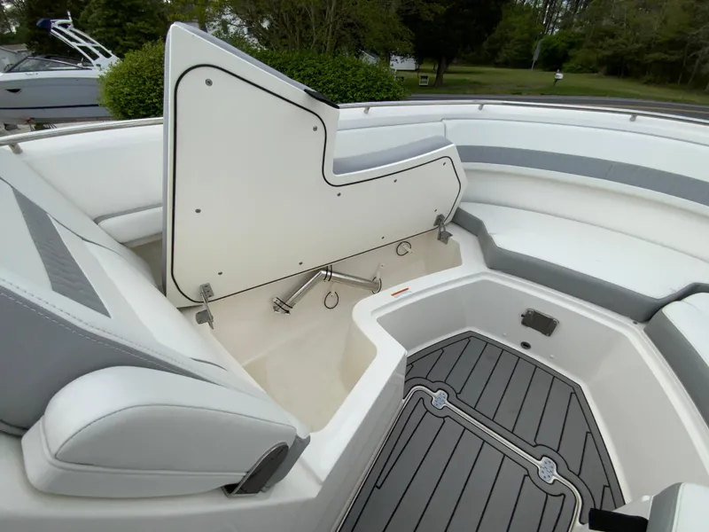 Slide: The Image of 2023 Pursuit DC 326 Dual Console boat interior with open storage compartment. - 30