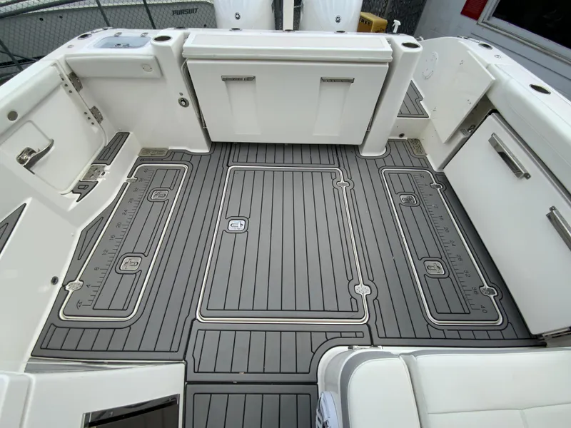 Slide: The Image of 2023 Pursuit DC 326 Dual Console boat deck with sleek, modern design and storage compartments. - 31