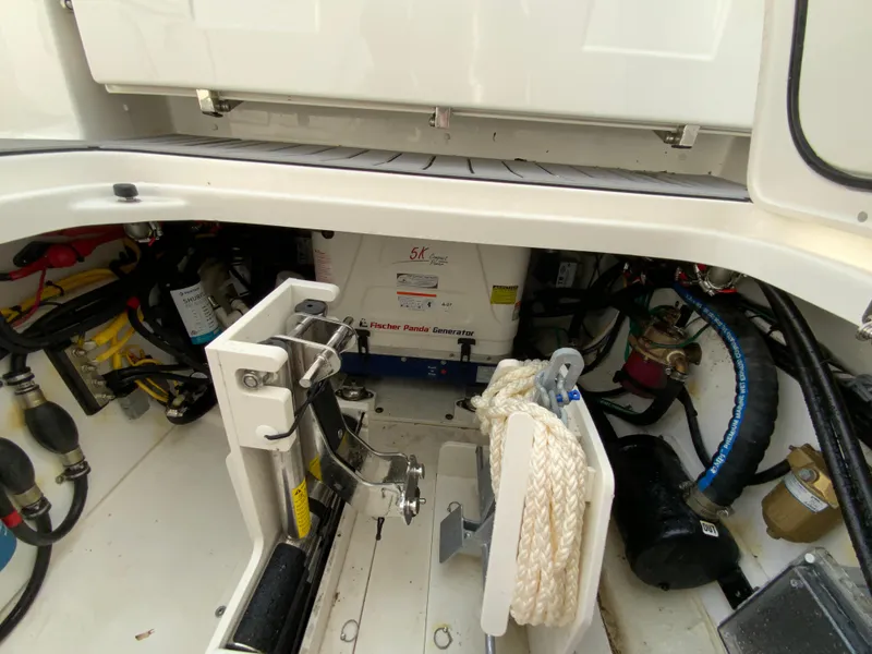 Slide: The Image of 2023 Pursuit DC 326 Dual Console boat engine compartment with generator and equipment. - 34