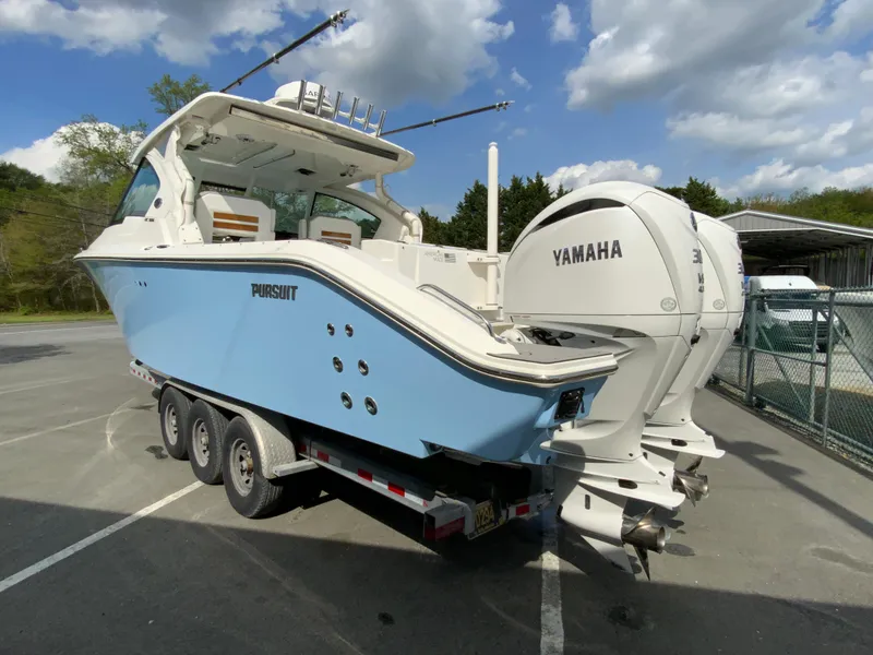 Slide: The Image of 2023 Pursuit DC 326 Dual Console boat with Yamaha engines on a trailer. - 7