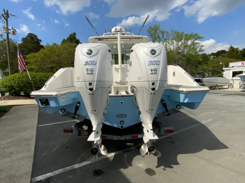 Slide: The Image of 2023 Pursuit DC 326 Dual Console boat with twin 300 V6 engines, parked outdoors. - 8